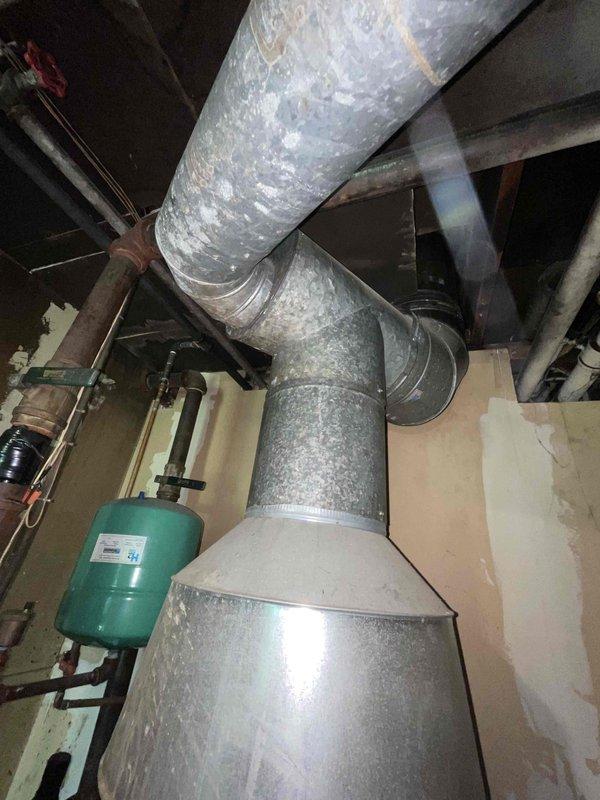 Conducted on-site assessment of existing boiler system and mechanical room infrastructure for equipment replacement estimate. Evaluated current heating system configuration including vertical flue venting, ductwork connections, expansion tank, and associated piping network to determine scope of work and equipment specifications required for new boiler installation.