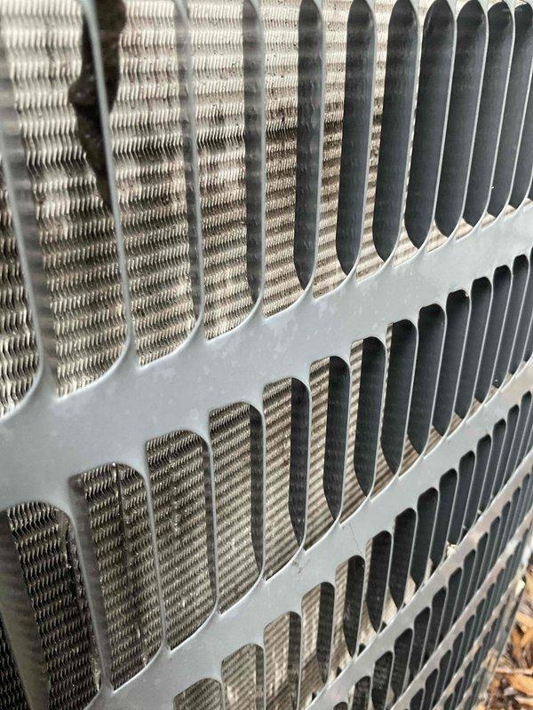 Completed comprehensive BFMA tune-up service on a 10+ year old air conditioning system, including full inspection and maintenance of condenser unit. Documented condenser coil condition showing moderate dust and debris accumulation between fins, with visible buildup affecting heat transfer efficiency. Performed standard tune-up procedures to ensure optimal system performance for the cooling season.