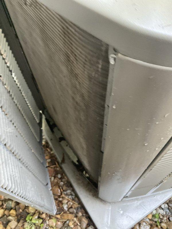 Completed comprehensive BFMA tune-up service on residential air conditioning system over 2 years old during morning appointment window. Upon arrival, found outdoor condenser unit with heavy dirt and debris accumulation on exterior coil fins and significant buildup of leaves, twigs, and organic matter in bottom drain pan. Performed thorough cleaning of condenser coils, removed all debris from unit interior and drain pan, inspected all electrical connections and refrigerant lines, verified proper system operation, and confirmed adequate airflow through heat exchanger. Unit returned to optimal operating condition with improved efficiency.