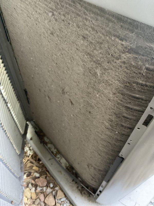 Completed comprehensive BFMA tune-up service on residential air conditioning system over 2 years old during morning appointment window. Upon arrival, found outdoor condenser unit with heavy dirt and debris accumulation on exterior coil fins and significant buildup of leaves, twigs, and organic matter in bottom drain pan. Performed thorough cleaning of condenser coils, removed all debris from unit interior and drain pan, inspected all electrical connections and refrigerant lines, verified proper system operation, and confirmed adequate airflow through heat exchanger. Unit returned to optimal operating condition with improved efficiency.