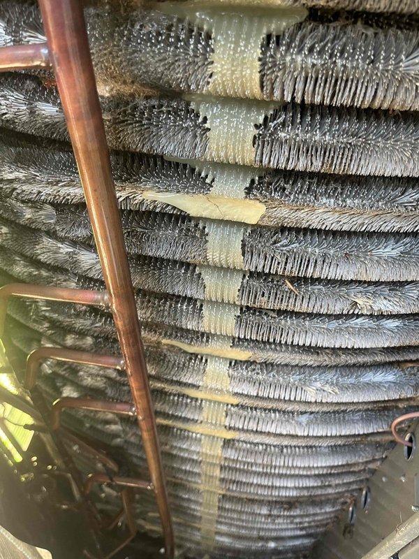 Completed comprehensive BFMA air conditioning tune-up on 4-year-old system. Performed full system inspection including evaporator coil assessment, refrigerant line examination, and operational testing. Documented heavy dust and debris accumulation on cylindrical evaporator coil assembly with visible contamination across finned surfaces, copper refrigerant lines showing normal oxidation patina, and evidence of previous repairs with tape reinforcement on coil sections. Verified all mechanical components, conducted standard maintenance procedures per BFMA protocol, and ensured system operational efficiency. Unit running within normal parameters upon completion.