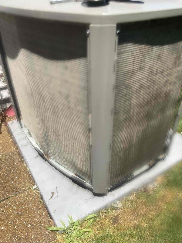 Completed comprehensive BFMA tune-up service on outdoor heat pump/air conditioning unit with 2+ years of service life. Performed standard maintenance procedures including inspection of condenser coils behind protective grilles, which showed moderate dirt accumulation and debris buildup requiring attention. Unit is positioned on concrete pad with proper clearances maintained, and all exterior components were assessed for operational readiness.