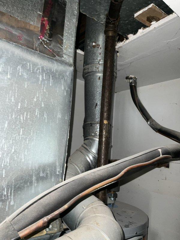 Conducted comprehensive full system HVAC estimate at residential property. Evaluated existing mechanical infrastructure including aged ductwork, refrigerant lines, and vertical pipe configurations in utility space. Assessed electrical service panel with multiple circuit breakers showing signs of wear and age, noting Ground Fault Circuit Breaker components and overall system capacity for new equipment compatibility. Documented current HVAC system layout including galvanized ductwork, insulated refrigerant lines, and mechanical space configuration to determine optimal replacement equipment specifications and installation requirements.