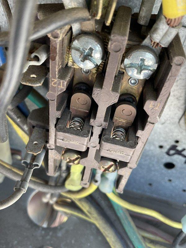 Responded to second floor RTU tripping breaker upon startup. Inspected electrical connections at contactor assembly and found evidence of corrosion and heat damage on terminal blocks. Cleaned and tightened all electrical connections at contactor terminals. Verified proper wire seating in spring-loaded terminal clamps. Unit tested successfully with no further breaker trips. System operating normally with proper amperage draw.