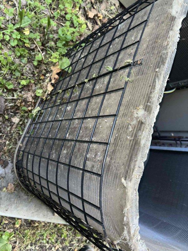 Completed comprehensive BFMA tune-up service on 16+ year old outdoor AC unit. Performed thorough system inspection, replaced heavily soiled air filter with proper 113 specification filter, cleaned condenser coils showing significant debris accumulation, and verified refrigerant line connections and electrical components. Unit exhibited extensive weathering with oxidized copper lines, mineral deposits in drain pan, and substantial dirt buildup; all maintenance items addressed per BFMA protocol to restore optimal system performance.