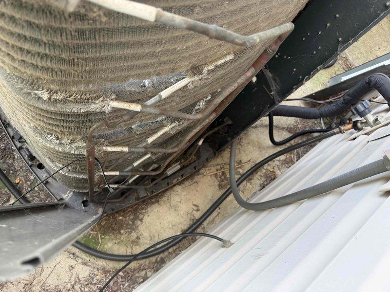 Completed comprehensive BFMA tune-up service on a 5-year-old outdoor air conditioning unit. Upon arrival, found condenser coils heavily clogged with dirt, dust, and debris accumulation that was significantly restricting airflow and reducing system efficiency. Performed thorough coil cleaning to remove all debris buildup from fins, inspected all electrical connections and wiring including capacitor, checked refrigerant line connections, and verified proper system operation. Unit is now operating at optimal efficiency with restored airflow through clean condenser coils.