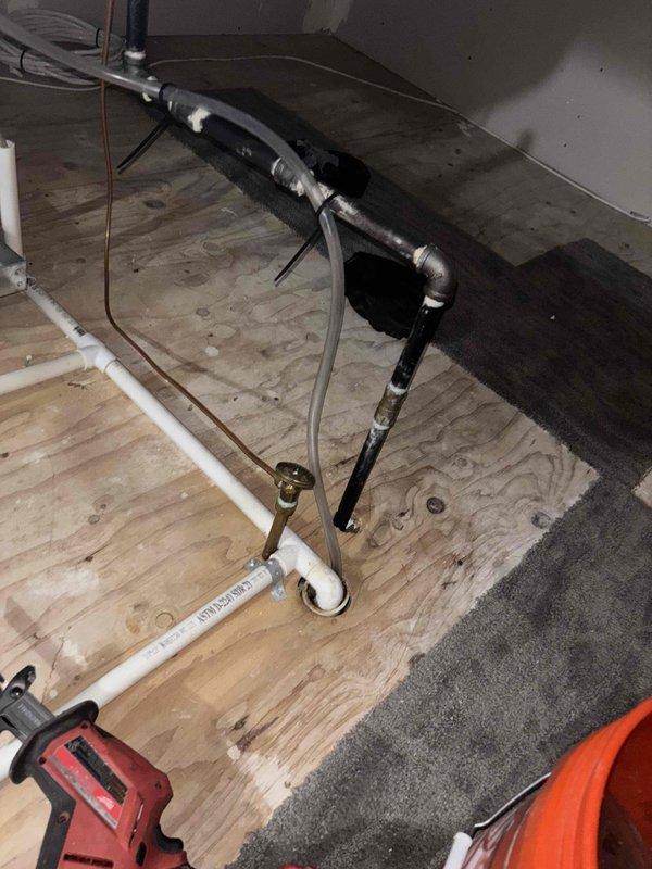 Installed drainage system to fresh air intake in attic mechanical space per customer request. Routed PVC piping across plywood flooring to prevent condensate accumulation at intake point, ensuring proper moisture management for HVAC system operation. All work completed in accordance with warranty specifications and manufacturer guidelines.