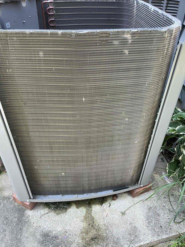 Completed routine BFMA tune-up on a five-year-old residential air conditioning system under active service plan. Performed comprehensive inspection of outdoor condenser unit, including visual assessment of coil condition, refrigerant lines, and electrical connections. Condenser coils showed moderate accumulation of dirt, dust, and organic debris throughout fin surfaces with visible lint buildup along top edges. All mechanical components operational with no immediate service concerns identified. Unit functioning within normal parameters at time of inspection.