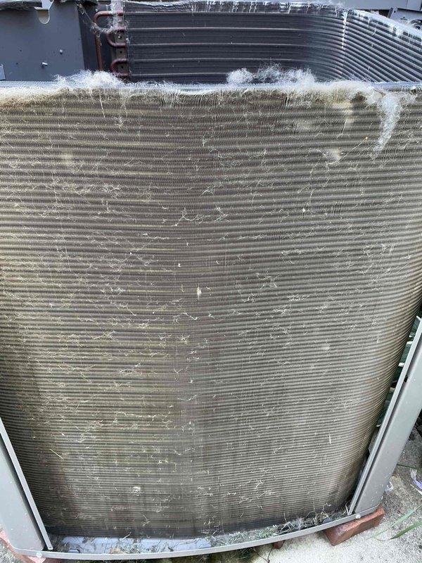 Completed routine BFMA tune-up on a five-year-old residential air conditioning system under active service plan. Performed comprehensive inspection of outdoor condenser unit, including visual assessment of coil condition, refrigerant lines, and electrical connections. Condenser coils showed moderate accumulation of dirt, dust, and organic debris throughout fin surfaces with visible lint buildup along top edges. All mechanical components operational with no immediate service concerns identified. Unit functioning within normal parameters at time of inspection.