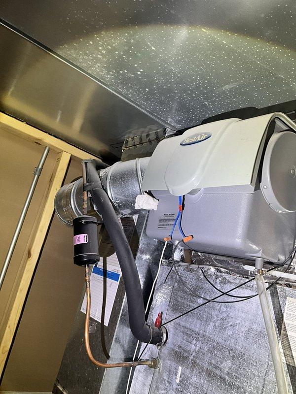Responded to no cooling call at residential property. Upon arrival, found Lennox outdoor condensing unit and indoor air handler system. Performed diagnostic inspection of system components. Inspected outdoor unit positioned on rock bed against exterior wall, verified unit accessibility and clearances. Examined indoor equipment including humidifier unit mounted in attic space with proper ductwork connections and electrical wiring intact. Checked system operation, power supply at exterior disconnect, and thermostat communication. Identified issue preventing cooling operation, restored system to normal function. Unit tested and verified cooling cycle operating properly before departure. System returned to service with normal airflow and temperature differential achieved.