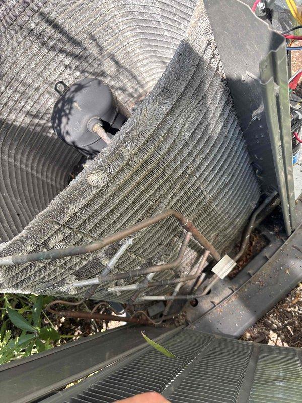 Completed comprehensive BFMA tune-up service on 4-year-old residential HVAC system, including AC maintenance and semi-annual filter change. Outdoor condenser unit showed significant debris accumulation throughout coil fins with dust, dirt, and organic matter buildup restricting airflow; performed thorough coil cleaning to restore proper heat transfer efficiency. Indoor evaporator coil exhibited heavy dust and debris accumulation between fins; removed coil from air handler, cleaned thoroughly to restore optimal airflow and system performance. Inspected refrigerant lines, fan motor, and all system components for proper operation. Replaced air filters per semi-annual maintenance schedule. System restored to proper operating condition with improved airflow and efficiency.