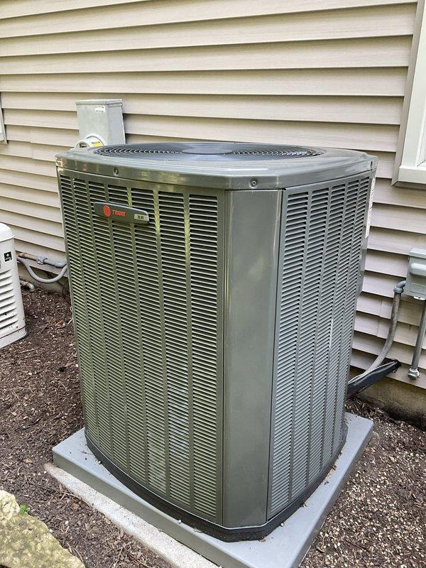 Performed routine preventive maintenance on three residential air conditioning systems, each approximately two years old and operating without reported issues. Conducted comprehensive tune-up procedures including inspection of condenser units, cleaning of heat exchanger coils showing visible dirt and biological growth accumulation, verification of refrigerant levels, testing of electrical components, and assessment of overall system performance. All units, including the Trane condenser observed with weathered aluminum fins and minor top edge deterioration, were confirmed operational with proper airflow through louver vents and functioning fan assemblies. Updated customer contact information in service records.