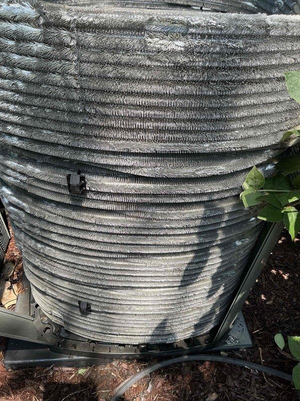 Completed comprehensive BFMA tune-up service on residential air conditioning system with equipment age of 5+ years. Upon arrival, found outdoor condenser coil heavily contaminated with dust, dirt, pollen, pet hair, and organic debris significantly restricting airflow through fins. Performed thorough coil cleaning to restore proper heat transfer efficiency. Removed and serviced evaporator coil, cleaning all fin surfaces to eliminate buildup and ensure optimal system performance. Inspected all major components, verified refrigerant levels, checked electrical connections, and tested system operation to manufacturer specifications. Unit now operating at peak efficiency with improved airflow and heat exchange capabilities.