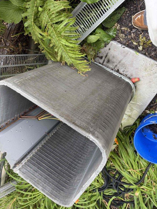 Completed semi-annual BFMA tune-up service on 22-year-old HVAC system, including full AC maintenance and filter replacement. Inspected and serviced outdoor evaporator coil unit, which showed normal wear and debris accumulation consistent with equipment age. Replaced heavily soiled accordion-style pleated air filter with new filter to restore proper airflow and system efficiency.