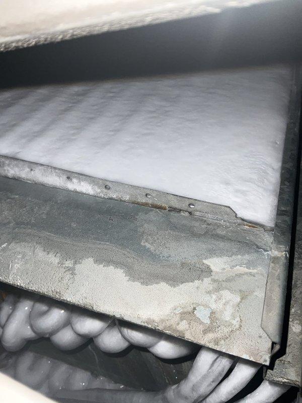 Responded to a no-cooling callback following previous service visit in early July. Upon arrival, found indoor temperature at 78°F with system not operating properly. Performed diagnostic inspection of air handling unit and evaporator coil assembly. Inspected condensate drainage system including drain pan and PVC discharge lines. Examined refrigerant line connections and verified proper installation of all HVAC components. Documented equipment condition with photos showing evaporator coil fins, metal housing panels with dust accumulation, and complete condensate management system with safety switches and drain lines.