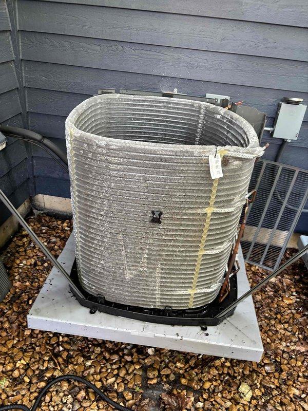 Completed comprehensive BFMA tune-up service on a 9-month-old air conditioning system. Inspected air handler unit and confirmed clean pleated air filter properly seated in housing with secure frame installation. Performed exterior condenser unit evaluation, noting heavy accumulation of dirt, dust, and debris on condenser coil fins requiring cleaning to restore optimal heat transfer efficiency and system performance.