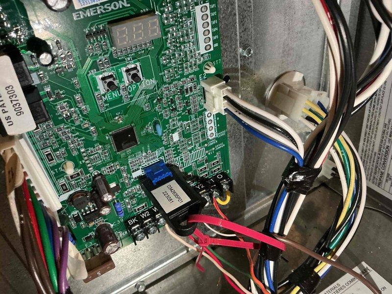 Completed comprehensive BFMA tune-up service on a 9+ year old air conditioning system, including full system inspection and performance evaluation. Inspected and documented Emerson control board operation with digital display and relay components functioning properly, verified all wire connections and terminals at capacitor assembly, and confirmed electrical connections were secure throughout the unit. All components tested within normal operating parameters and system is ready for continued service.