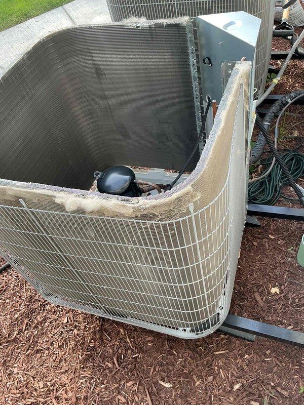 Completed comprehensive air conditioning tune-up service on two Carrier condenser units. Performed standard maintenance procedures including inspection of electrical components, refrigerant lines, and condenser coils. One unit was found with significant damage to the top protective grille and casing, exposing internal condenser coil and compressor components, with torn insulation material present; documented condition with photographs for customer review and future repair consideration.