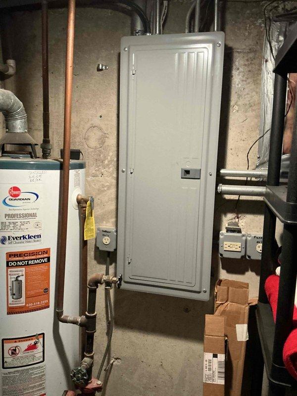 Conducted on-site evaluation of 12-year-old central air conditioning system to provide replacement estimate. Inspected outdoor condenser unit with cylindrical design and top-mounted fan assembly, noting weathered exterior finish consistent with age and outdoor exposure. Assessed electrical disconnect box, conduit routing, and power supply connections at exterior installation. Evaluated indoor electrical panel and existing infrastructure in basement utility area to determine compatibility requirements for new equipment installation. Documented current system configuration, mounting pad condition, and clearance specifications. Provided comprehensive equipment replacement quote including condenser unit and evaporator coil to address aging system nearing end of service life.
