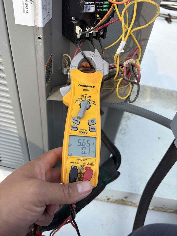 Completed preventive maintenance tune-up on rooftop HVAC unit (7+ years old) that was rescheduled from previous no-cool service calls. Performed comprehensive system inspection including visual assessment of evaporator coil which showed moderate dirt and debris accumulation on fins. Conducted electrical diagnostics using digital multimeter, measuring voltage and amperage at contactor and verified proper electrical connections. All colored control wiring and power connections inspected and found secure. System operational parameters checked and unit running within normal specifications at time of service completion.