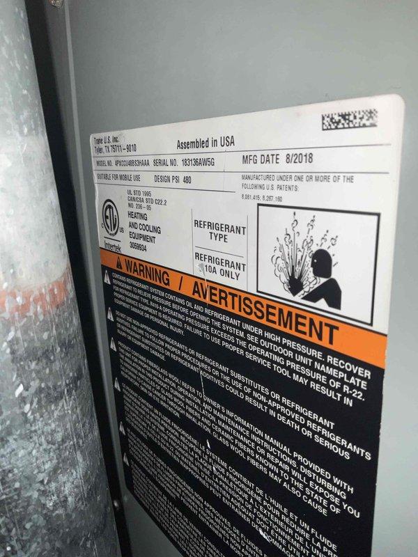 # HVAC Service Completed

Responded to residential no cooling call with thermostat set to 68°F but temperature holding at 75°F. Inspected Goodman packaged unit model PPGD048036AA, manufactured August 2018, utilizing R410A refrigerant. Upon inspection, observed significant condensation on interior metal panel indicating active cooling cycle but insufficient heat transfer. Examined refrigerant distribution valve assembly and associated copper line connections for potential restrictions or refrigerant flow issues. Documented equipment nameplate specifications and internal valve configuration with service photos. Unit assessed for proper refrigerant charge levels, airflow restrictions, and component operation to determine root cause of inadequate cooling performance.