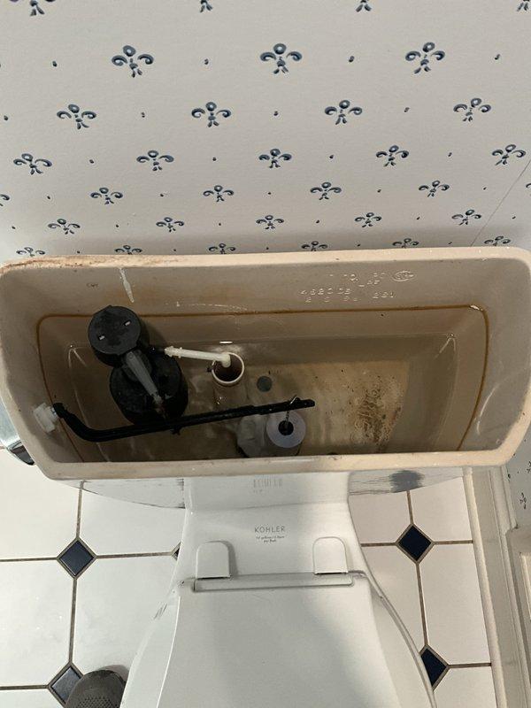 Responded to service call for toilet experiencing continuous running, low water level in tank, and frequent clogging issues. Upon inspection, found deteriorated flapper valve and flush valve assembly with visible sediment and mineral deposits throughout tank interior. Replaced defective flapper and adjusted fill valve to restore proper water level and stop running condition. Tested flush mechanism multiple times to ensure proper operation and verified tank refill cycle functioning correctly. Toilet now operating normally with appropriate water level and no running issues.