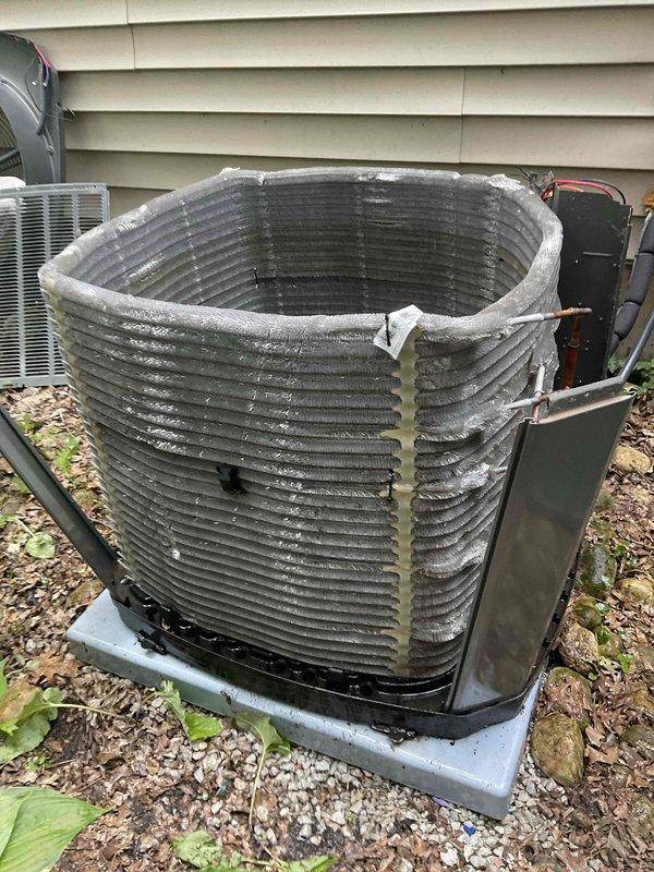 Performed comprehensive BFMA tune-up on Trane air conditioning system including complete inspection of condenser unit, verification of electrical connections and capacitor function, and assessment of refrigerant lines. Observed mineral deposits and white residue accumulation on condenser coil surfaces requiring attention during service, cleaned accessible components, and verified proper system operation. Unit is operational with all safety checks completed and system running within normal parameters.