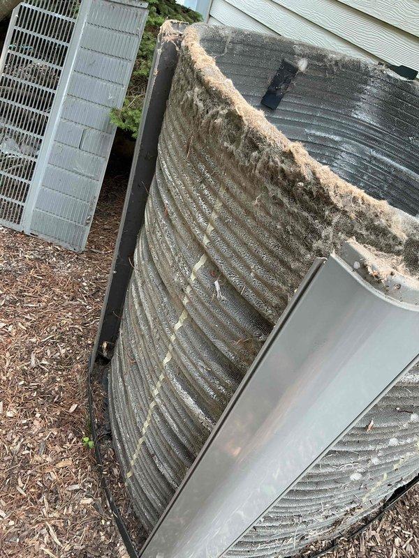 # HVAC Maintenance - BFMA Tune Up

Completed comprehensive preventive maintenance tune-up on a 17-year-old Freedom80 Comfort-R HVAC system. Performed standard inspection and cleaning procedures on both indoor and outdoor components. 

Inspected and compared return air filters, noting significant dust and debris accumulation on existing filter requiring replacement. Filter showed heavy brownish-gray coating across mesh surface, restricting proper airflow. Installed clean replacement filter to restore optimal system performance and indoor air quality.

Serviced outdoor condenser unit, which exhibited heavy contamination on coil fins. Coil surface displayed thick beige-colored accumulation of dirt, lint, and organic debris creating diagonal stripe pattern across upper portion. Identified dark patches of mold and mildew growth on multiple areas of aluminum fins. Thoroughly cleaned condenser coils to remove environmental buildup and restore heat transfer efficiency. Cleared obstructions fro