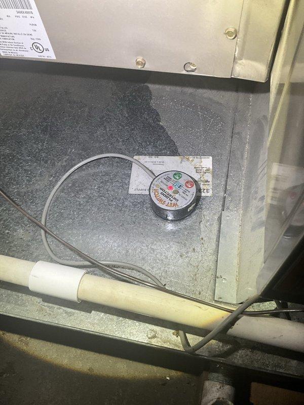 Responded to commercial HVAC service call for multiple rooftop units experiencing operational issues. Evaluated three separate units, including one that had frozen up during previous day's service. Performed diagnostic testing using refrigerant charging scale to assess system pressures and refrigerant levels. Inspected condensate drainage systems and evaporator coil conditions on affected units. Documented equipment conditions with photos showing moisture accumulation in drain pans and measurement readings. Addressed immediate cooling failures to restore operation to commercial facility.