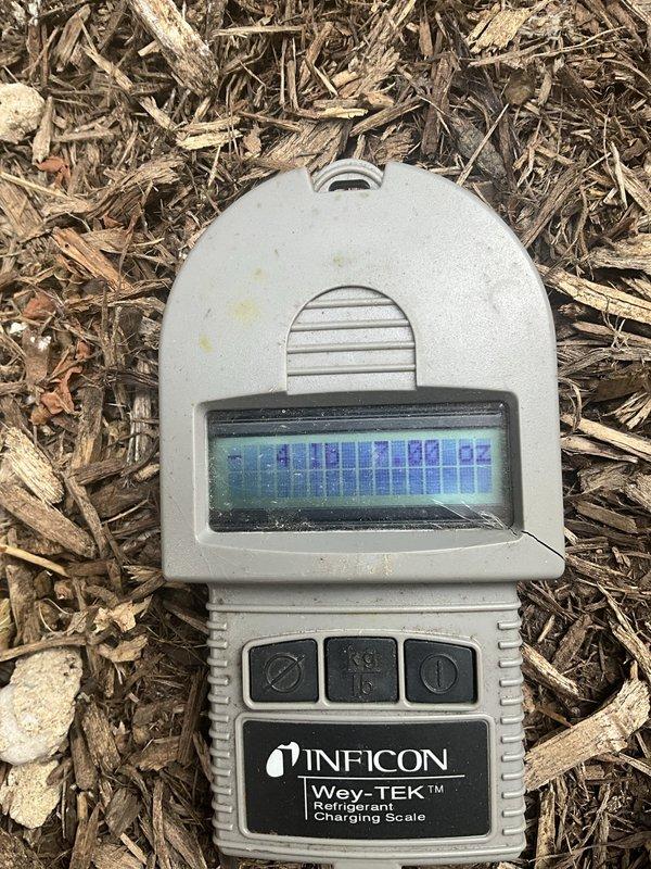 Responded to commercial HVAC service call for multiple rooftop units experiencing operational issues. Evaluated three separate units, including one that had frozen up during previous day's service. Performed diagnostic testing using refrigerant charging scale to assess system pressures and refrigerant levels. Inspected condensate drainage systems and evaporator coil conditions on affected units. Documented equipment conditions with photos showing moisture accumulation in drain pans and measurement readings. Addressed immediate cooling failures to restore operation to commercial facility.