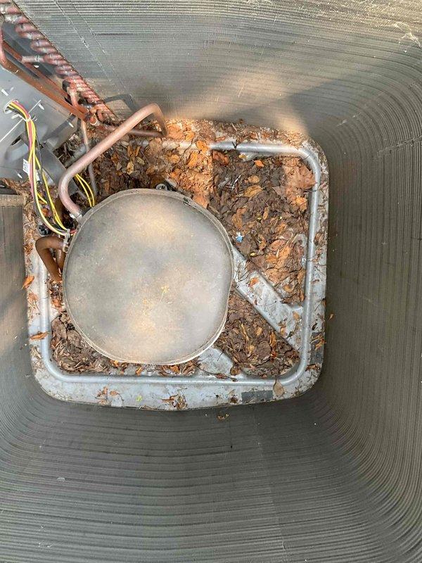 Completed comprehensive BFMA tune-up service on a 5-year-old air conditioning system. Upon arrival, performed electrical diagnostics using clamp meter to verify amperage draw and system performance parameters. Inspected outdoor condensing unit and discovered significant debris accumulation in condensate drain pan, including leaves, twigs, and organic matter that had collected over time. Cleaned drain pan thoroughly, removing all debris to prevent potential drainage issues and ensure proper condensate flow. Inspected refrigerant lines, electrical connections, and drain components for wear and proper operation. Verified all electrical readings were within manufacturer specifications and system was operating efficiently following cleaning and inspection procedures.
