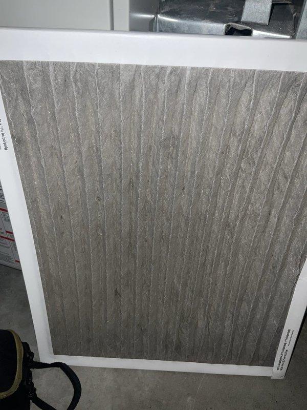 Responded to no cooling call where system was blowing lukewarm air. Upon arrival, found heavily soiled air filter restricting airflow to the system. Inspected outdoor condensing unit and verified equipment condition. Replaced dirty air filter with new filter to restore proper airflow. System operational upon departure.