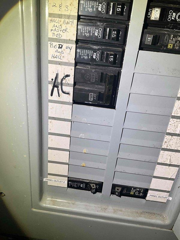 Conducted comprehensive sales estimate for complete air conditioning system and evaporator coil replacement in residential basement mechanical room. Evaluated existing white cabinet furnace unit with connected ductwork, assessed galvanized metal duct configuration extending through ceiling joists, and inspected PVC condensate drainage routing. Reviewed electrical panel capacity and circuit breaker configuration to verify adequate 15-amp circuits available for new HVAC equipment installation, noting existing AC circuit designation. Documented current system layout including ductwork connections, equipment positioning relative to water heater, and available workspace for proposed A/C and coil installation.