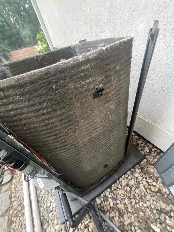 Replaced defective high pressure safety switch on outdoor condensing unit and performed thorough coil cleaning to restore proper system operation. Unit exhibited significant biological growth and debris accumulation on condenser coil fins, which was restricting airflow and contributing to elevated head pressures that triggered the safety switch failure. Chemically cleaned condenser coil to remove algae, mildew, and organic buildup, then rinsed thoroughly to restore heat transfer efficiency and proper refrigerant pressures.