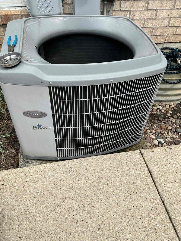Completed comprehensive BFMA tune-up on 22-year-old Carrier Puron air conditioning system. Performed electrical diagnostics using clamp meter to verify amperage draws on blower motor and compressor circuits, inspected all wire connections and terminals, and conducted full system evaluation. Unit operating within manufacturer specifications; all components functioning properly with no immediate concerns identified.