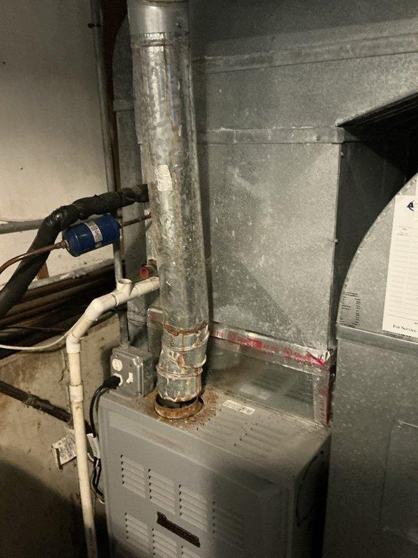 Installed a complete Trane XR13 R410a air conditioning system consisting of a 4TTR3042 outdoor condenser unit positioned on a concrete pad against the building exterior and a TAC42C1N indoor evaporator coil integrated with the existing air handler in the basement. The installation included a new thermostatic expansion valve (TXV) for proper refrigerant metering and a P200 pad for the outdoor unit, with all electrical connections completed and refrigerant lines properly insulated and secured.