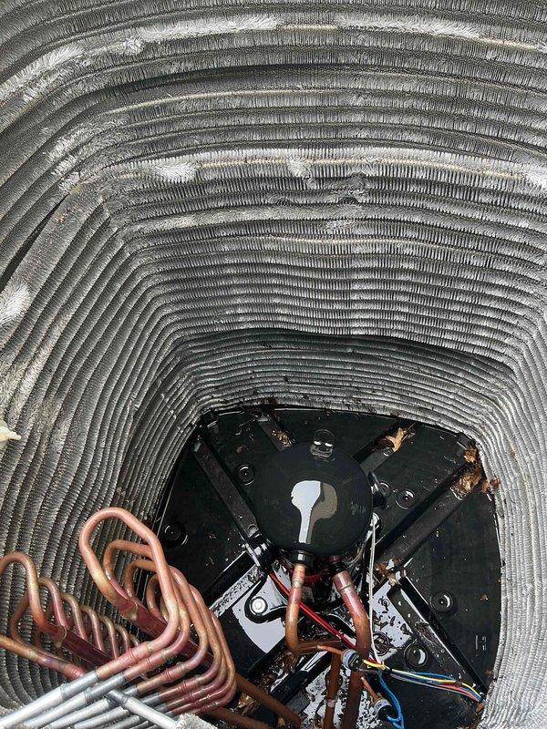 Completed comprehensive BFMA tune-up on air conditioning system, including full inspection of 2-year-old equipment. Performed detailed examination of evaporator coil assembly, condenser coil unit, refrigerant lines, and electrical connections. Documented significant debris accumulation on condenser coils requiring attention, with heavy buildup of dirt and environmental contaminants observed on heat exchanger surfaces affecting system efficiency.