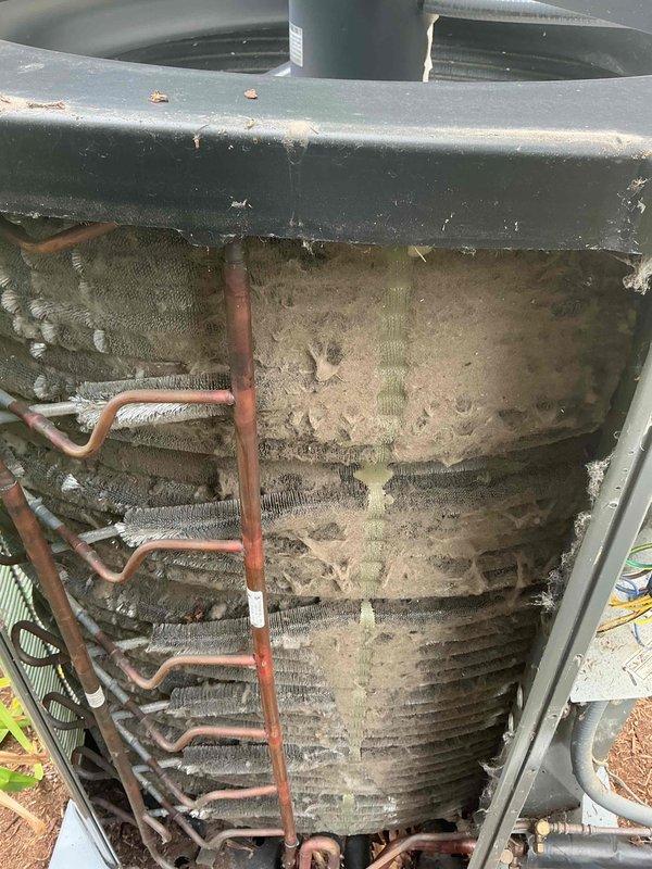 Completed comprehensive BFMA tune-up on air conditioning system, including full inspection of 2-year-old equipment. Performed detailed examination of evaporator coil assembly, condenser coil unit, refrigerant lines, and electrical connections. Documented significant debris accumulation on condenser coils requiring attention, with heavy buildup of dirt and environmental contaminants observed on heat exchanger surfaces affecting system efficiency.