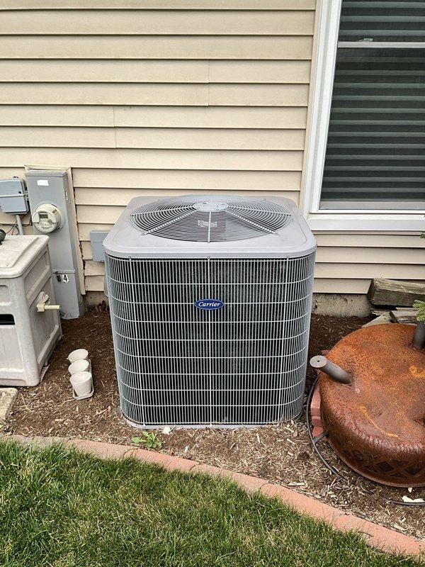 Completed comprehensive BFMA tune-up service on 15-year-old Carrier air conditioning system. Performed full preventive maintenance including inspection of outdoor condenser unit, verified proper operation of all components, checked electrical connections at disconnect and meter, and confirmed system is operating within manufacturer specifications. Unit showed good overall condition with clean coil fins and properly functioning fan assembly.