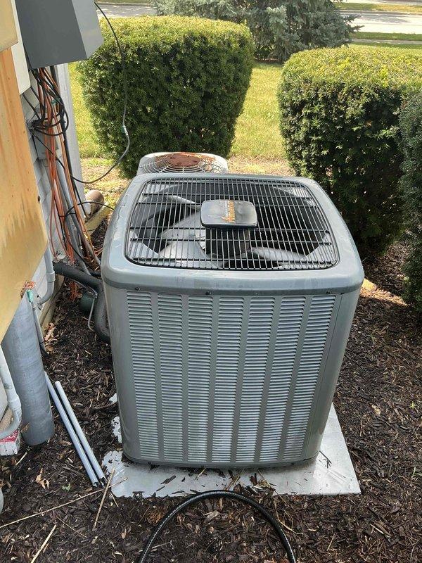 Completed comprehensive BFMA tune-up service on residential air conditioning system aged 4+ years. Performed thorough inspection of outdoor condenser unit, including examination of cabinet condition, fan assembly, and protective grille components. Verified proper installation on concrete pad and assessed surrounding clearances. Inspected evaporator coil assembly, noting moisture present on fins indicating normal operation. Cleaned and evaluated heat exchanger surfaces, checking for debris accumulation and verifying adequate airflow through finned components. Examined refrigerant line insulation and electrical conduit routing along exterior wall. Confirmed all mechanical components operating within specifications. Maintained communication with customer via phone throughout service visit as requested, providing updates on system condition and maintenance activities performed.