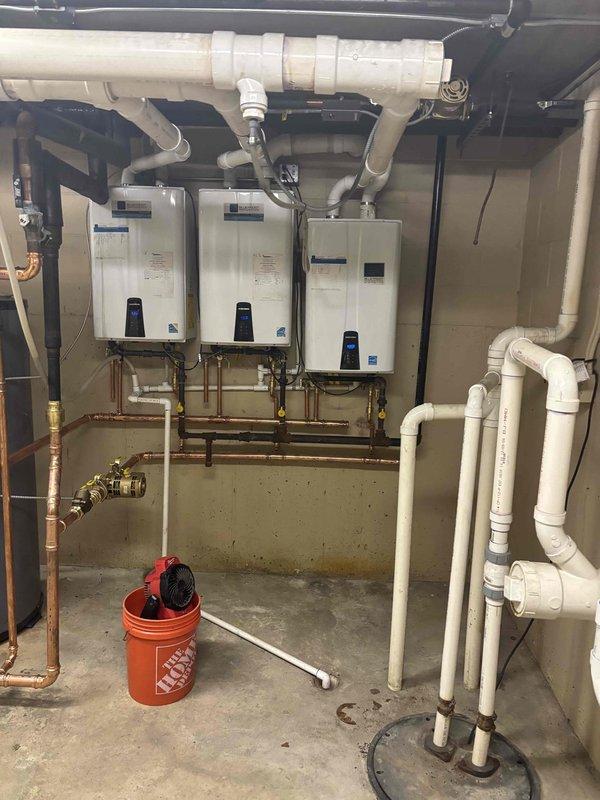 Responded to service call for lukewarm water complaint affecting multiple units. Upon inspection, found hybrid system with one tanked water heater and three wall-mounted tankless units working in tandem. Tested water temperature output from all units, inspected copper supply lines, verified gas supply and electrical connections, and checked all isolation valves and brass fittings for proper operation. Confirmed system configuration and identified potential capacity or sequencing issues with the multi-unit setup requiring further evaluation to restore adequate hot water delivery throughout the building.