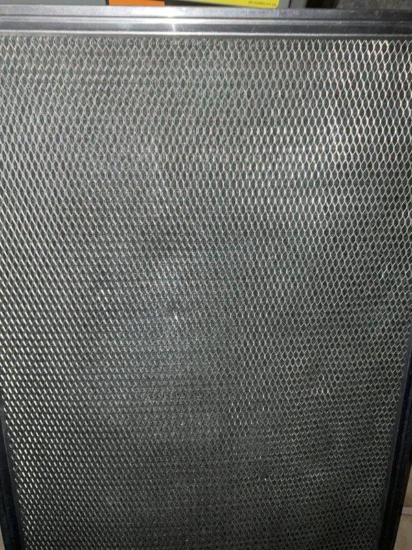 Completed non-member air conditioning tune-up on a 4-year-old lower-level AC unit. Upon inspection, discovered significant dust and lint accumulation throughout the system components, including heavy buildup on the evaporator coil assembly and internal framework. The mesh filter showed moderate debris collection. Thoroughly cleaned all accessible components, removed fibrous dust deposits from copper refrigerant lines and metal housing, and replaced/cleaned air filter. Verified system operation and airflow following maintenance. Documented pre-service conditions with photographs showing extent of contamination. System restored to proper operating condition with improved airflow efficiency.