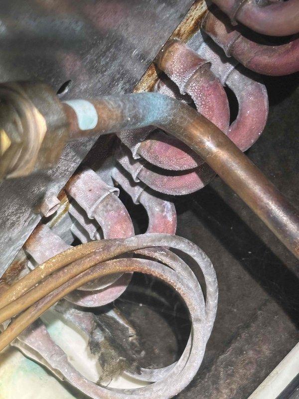 Responded to service call for furnace leaking water into sump pump area. Upon inspection, discovered heavy frost and ice accumulation on evaporator coil and refrigerant lines, indicating a restricted airflow condition or potential refrigerant issue. The excessive ice buildup was causing water overflow as the system cycled and frost melted. Advised customer that unit had been properly shut down to prevent further water damage. Documented equipment condition with photographs showing frosted copper tubing, oxidized components, and accumulated debris within cabinet. Recommended thorough system evaluation including airflow assessment, filter inspection, and possible drain line verification once ice has fully melted to determine root cause and prevent recurrence.