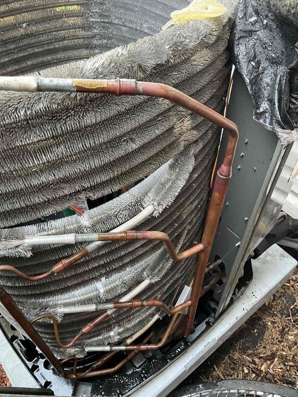 Completed comprehensive BFMA tune-up service on 3-year-old Trane air conditioning system. Upon inspection, discovered significant accumulation of debris, dust, and lint heavily impacting the condenser coil, with buildup several inches thick throughout the aluminum fins, severely restricting airflow and reducing system efficiency. Thoroughly cleaned condenser coil to restore proper heat transfer capability, inspected refrigerant lines and connections, verified electrical components, and tested system operation to ensure optimal performance.