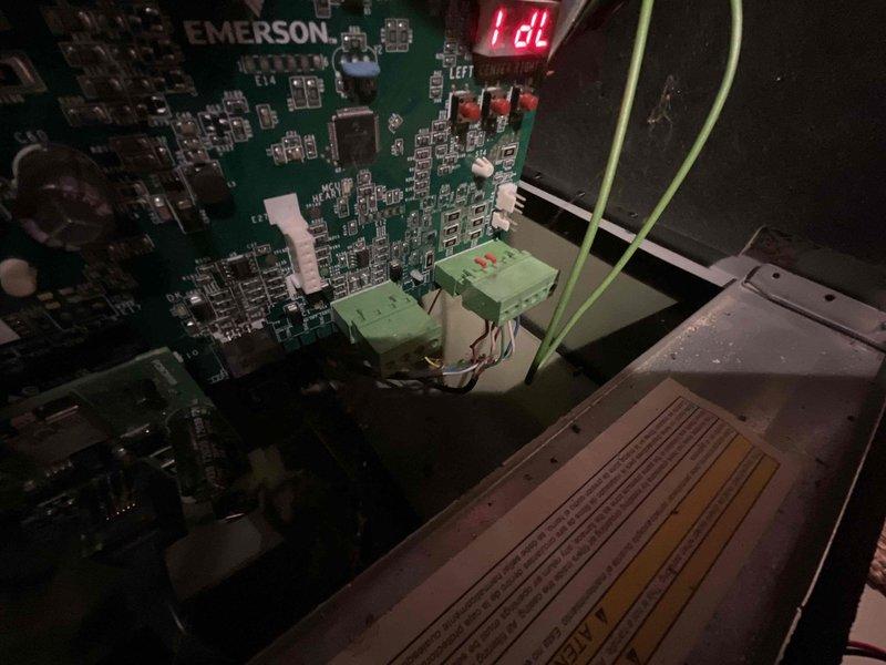 Responded to no cooling call at residential property. Upon arrival, inspected thermostat and HVAC system in basement utility area. Examined Emerson control board and found system displaying "IdL" (idle) status with all components appearing normal. Tested thermostat operation and system controls - no trouble found with equipment. System powered on successfully and operated as designed. All electrical connections, relays, and control board functions tested within normal parameters.