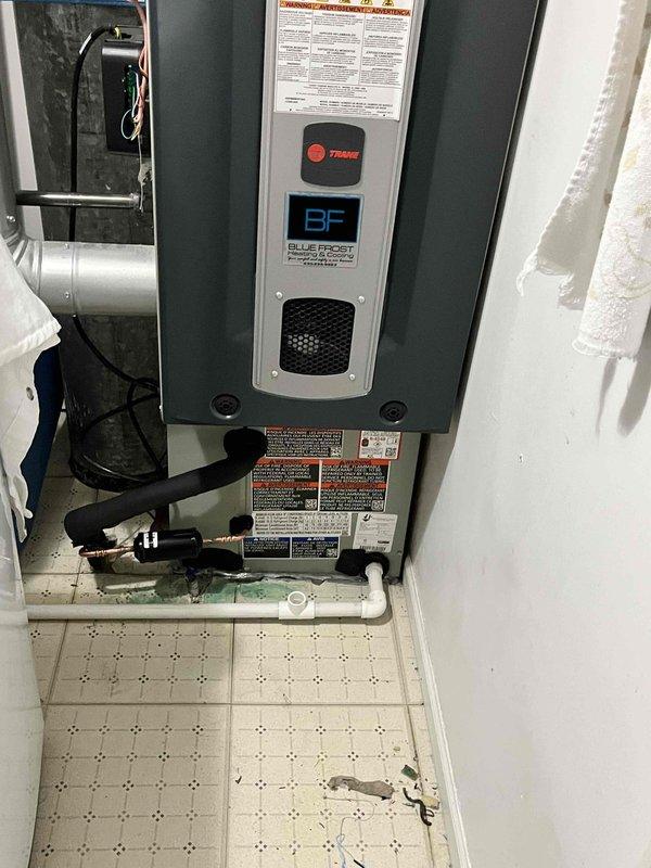 Completed installation of upgraded Trane 5TTR6030 16 SEER air conditioning system with matching ADP upflow/downflow evaporator coil. Removed and reinstalled existing downflow furnace to accommodate the new coil configuration, which required additional clearance due to increased coil height. System installed on exterior concrete pad, charged with refrigerant, tested for proper operation, and verified all connections secure.