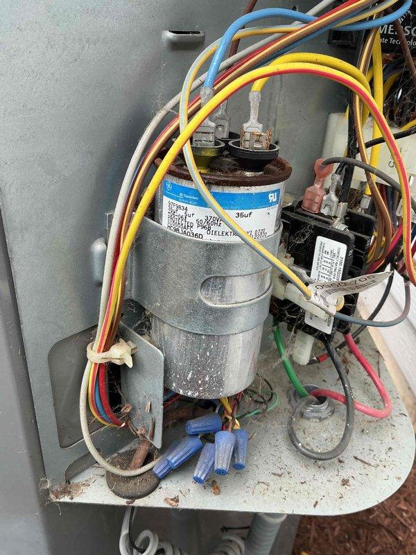 Performed comprehensive BFMA tune-up on 10-year-old residential air conditioning system during afternoon appointment to accommodate tenant schedule. Accessed outdoor condenser unit, removed top panel for internal inspection, and evaluated refrigerant lines and coil assembly condition. Identified heavily corroded capacitor terminals with significant rust accumulation requiring monitoring, inspected electrical control panel components including contactor and wiring connections, cleaned condenser unit exterior showing age-related weathering, and verified all electrical connections secure despite visible corrosion on capacitor. System operational upon completion with recommendations for future capacitor replacement due to terminal deterioration.
