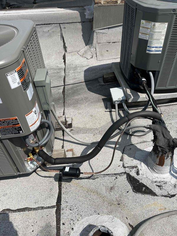 Completed full HVAC system replacement, consolidating two existing rooftop units into a single system configuration. Utilized existing trunk lines and return ductwork while capping off original line sets and electrical connections to preserve future zoning capabilities. Fabricated and installed custom ductwork to integrate the two separate systems into one unified operation. Coordinated crane service for rooftop equipment placement and removal. Installed new condensing unit with refrigerant lines and electrical connections. Verified system operation with diagnostic testing equipment, confirming proper refrigerant pressures and temperatures. All components secured and operational on rooftop concrete pad.