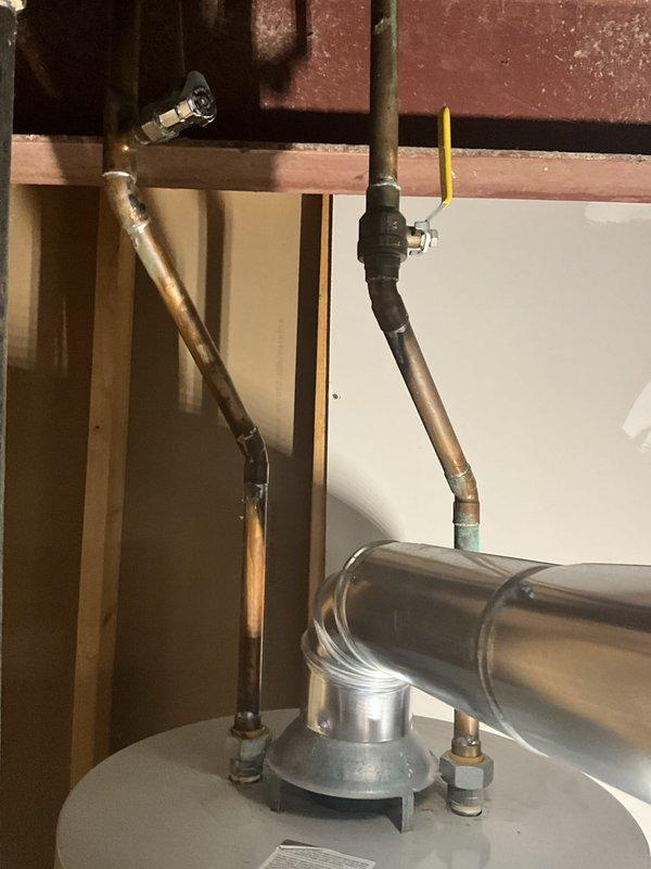 Completed comprehensive plumbing inspection as part of tune-up service, which was coordinated with AC maintenance performed on the same day. Inspected water heater installation, copper supply piping, shut-off valves, and connections, verifying all components were functioning properly with no visible leaks or deficiencies noted. Documented plumbing infrastructure including exposed piping in basement area for service records.