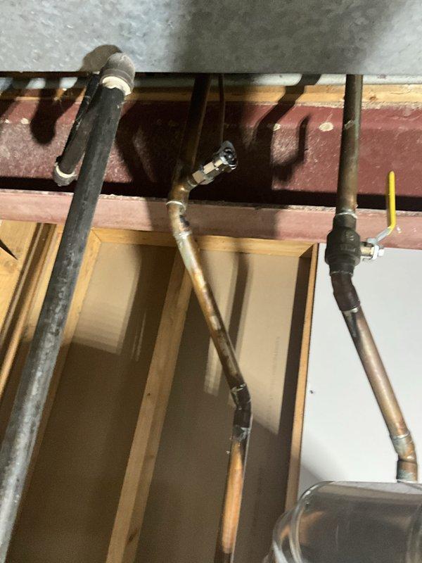 Completed comprehensive plumbing inspection as part of tune-up service, which was coordinated with AC maintenance performed on the same day. Inspected water heater installation, copper supply piping, shut-off valves, and connections, verifying all components were functioning properly with no visible leaks or deficiencies noted. Documented plumbing infrastructure including exposed piping in basement area for service records.